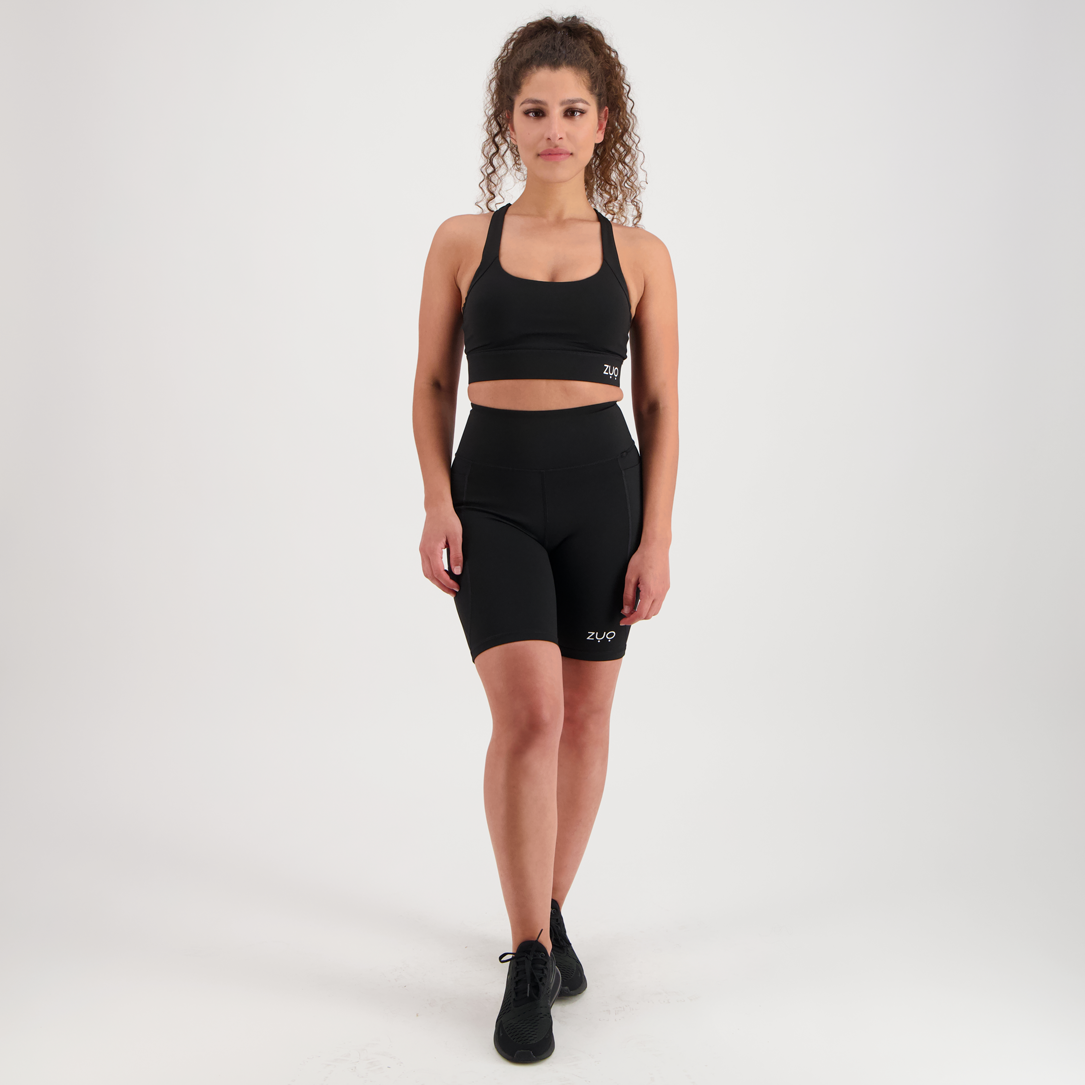 Front view, model in mid-length shorts in black